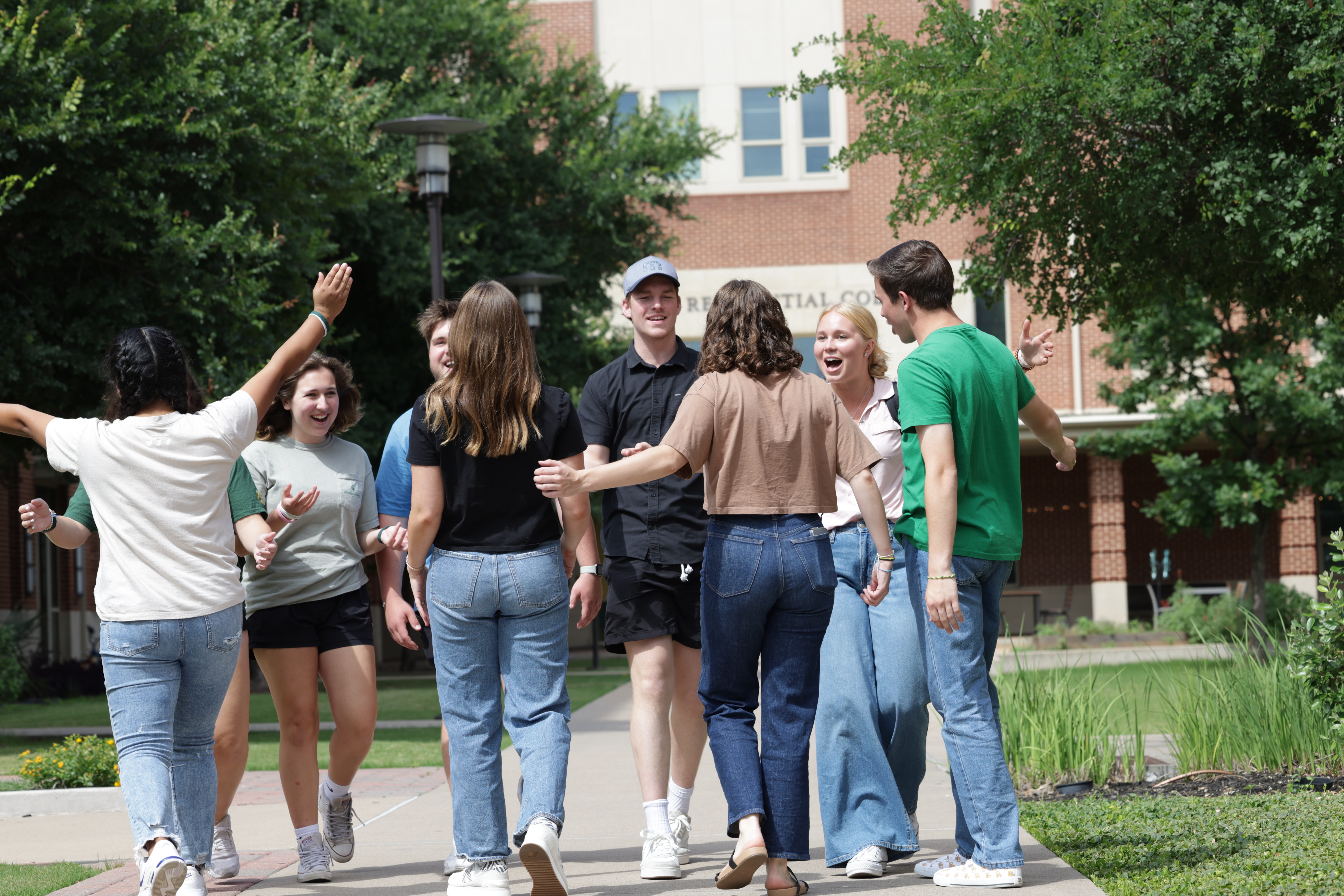 College students on Baylor University's campus greeting each other