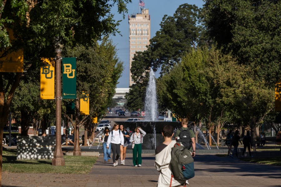 Baylor students walking down Fifth Street with views of Fountain Mall on Baylor's Campus